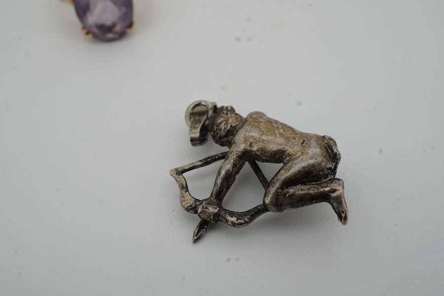 An amethyst ring and a pendant, the ring set with an oval amethyst, mounted in 9ct gold, size N, British hallmarks; the pendant modelled as an archer, length 3.6cm